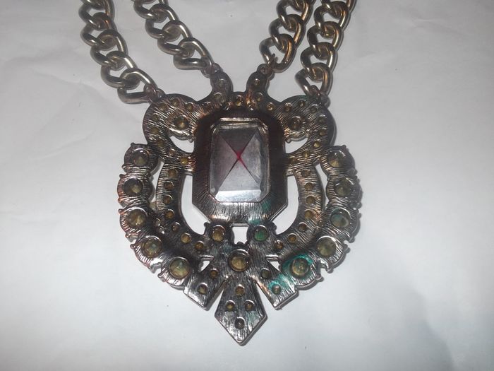 a lovely vintage  costome jewelley pendent with white stones and a large red stone