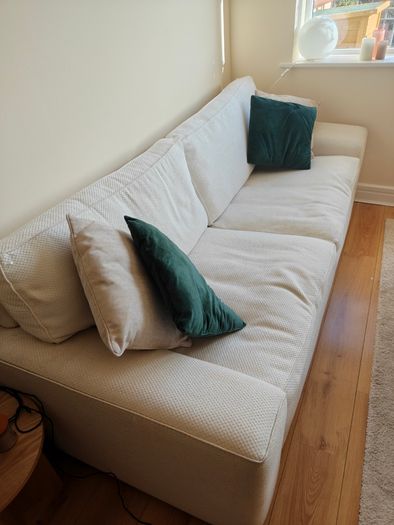 Cream fabric three-seater sofa