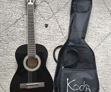 Koda black guitar 1/2 size, includes bag and pick