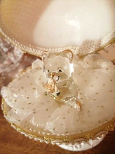 Glass hug bear in a shell case.