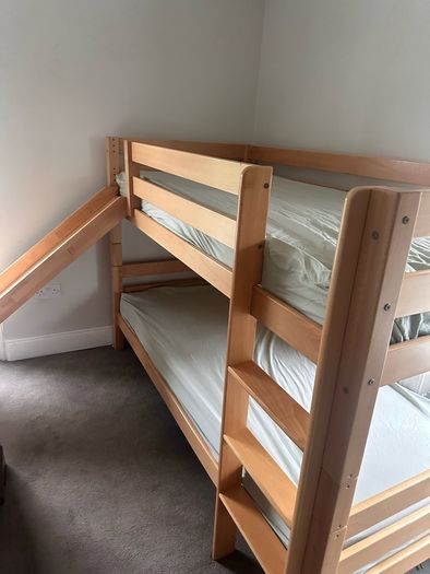 Bunk bed with attached slide and mattresses