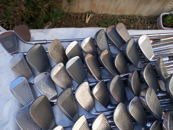 A selection of golf clubs and bags. All right handed clubs.