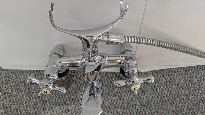 Retro bath mixer with handheld shower head.
