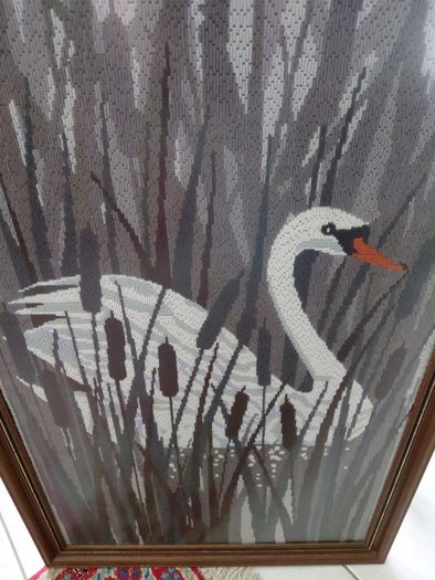 Vintage framed needlepoint tapestry depicting a white swan swimming