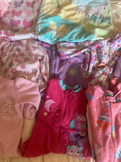 10 all in ones, 3 baby sleep bag, 4 pink blankets