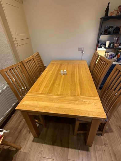 Solid oak dining table & 6 reupholstered dining chairs