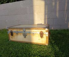 Beige storage trunk with metal fittings