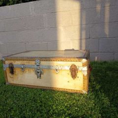 Beige storage trunk with metal fittings