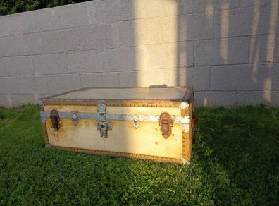 Beige storage trunk with metal fittings