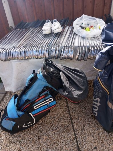 A selection of golf clubs and bags. All right handed clubs.