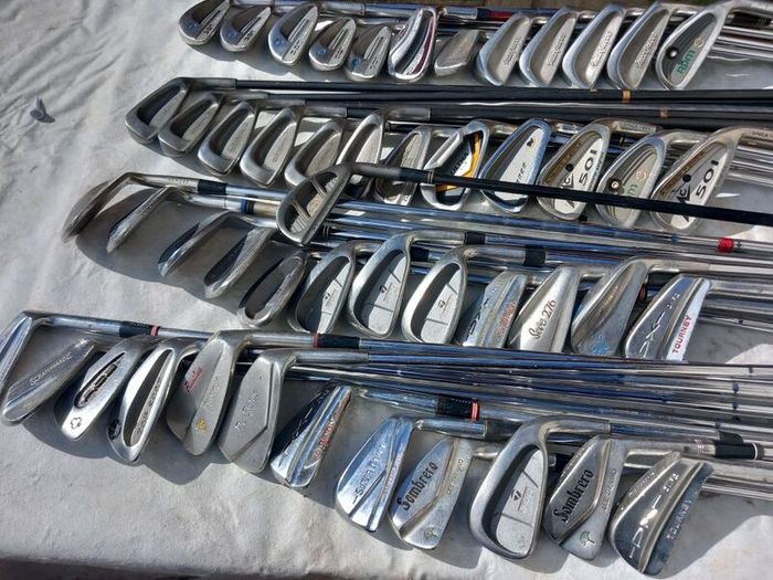 A selection of Golf clubs. Bags and golf balls.