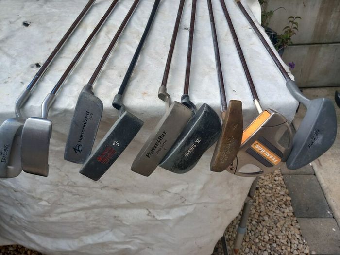 A selection of Golf clubs. Bags and golf balls.