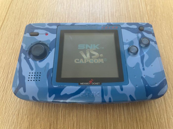 Neo Geo Pocket Color with game SNK vs. Capcom: Match of the Millennium