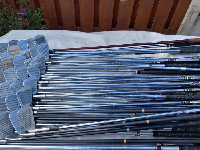 A selection of Golf clubs. Bags and golf balls.