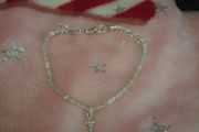silver bracelet and cross