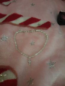silver bracelet and cross