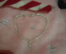 silver bracelet and cross