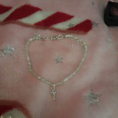 silver bracelet and cross