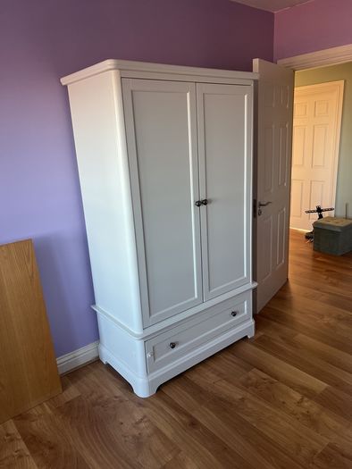 White double door high wardrobe with bottom drawer and shelf