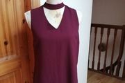 New look wine sleeveless top with choker neck. And zip opening at the back. size 8. Bust 18" length 24" New with tags