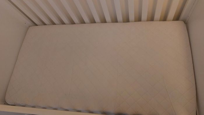 Cot that converts to toddler bed with underbed storage