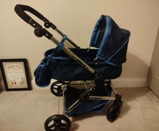 Doll Pram silver cross. Pristine condition except for a small rip on the basket . All accessories included as per picture. Never used outside