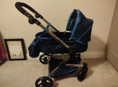 Doll Pram silver cross. Pristine condition except for a small rip on the basket . All accessories included as per picture. Never used outside