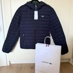 Lacoste Men's Lightweight Foldable Hooded Water Resistant Coat. size US M