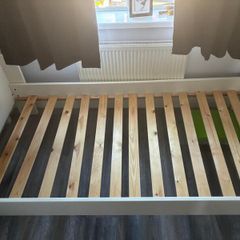 White single bed frame with wooden slats