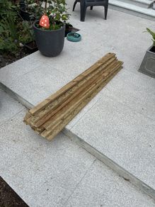 23 lengths of treated wood approx 1.3m long