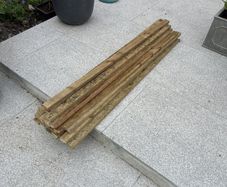 23 lengths of treated wood approx 1.3m long