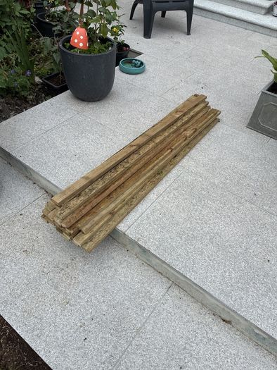 23 lengths of treated wood approx 1.3m long