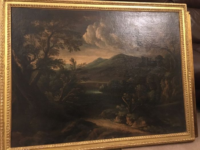 Circle of Francesco Zuccarelli  mountainous landscape by a lake with a fortress