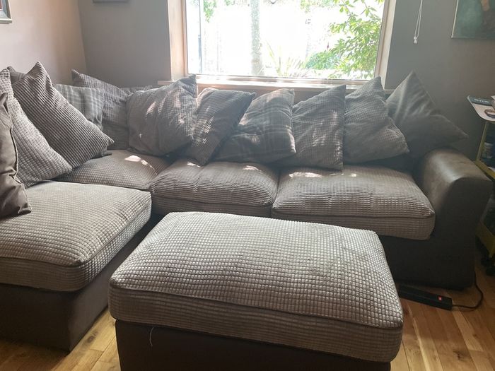 L shaped couch with poof