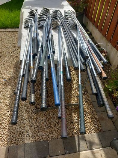 A selection of Golf clubs. Bags and golf balls.