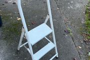 white metal 2-step folding household ladder with a high safety handrail.