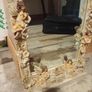 Rococo style wall mirror features a heavy, ornate resin frame decorated with carved cherubs and floral motifs Image 2