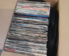 a box of 7" singles. 45 rpm vinyl records.