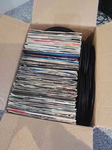 a box of 7" singles. 45 rpm vinyl records.