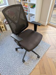 Black mesh office chair with adjustable armrests