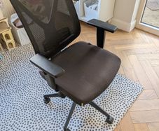 Black mesh office chair with adjustable armrests