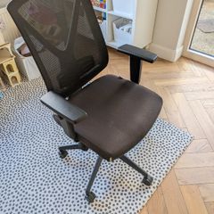 Black mesh office chair with adjustable armrests