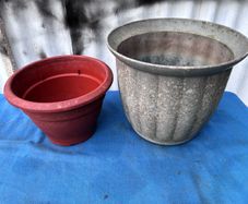 2 weathered plastic flower pots