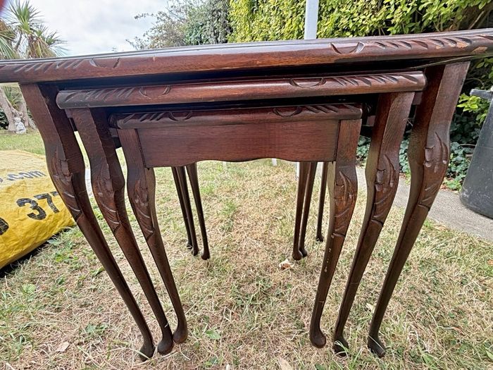 A vintage glass-protected, gold-tooled, leather top nest of tables