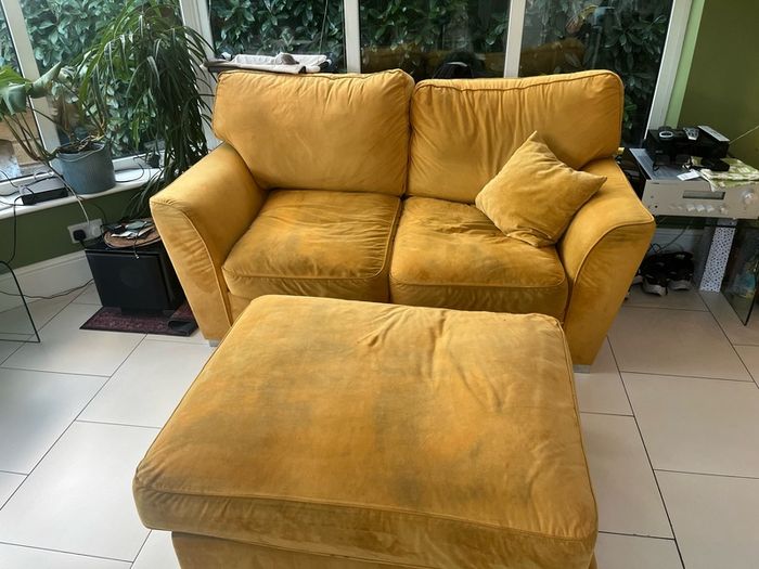 Mustard yellow velvet sofa with matching footstool