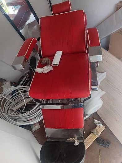 Beautiful red vintage Barbers chair with white piping