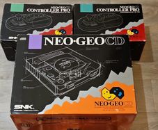 Neo Geo CD top loader + 2x boxed controllers