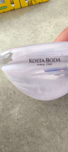 A Small Kosta Boda Art Glass Bowl with White Swirl Detail