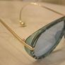 Aviator sunglasses with blue lenses and gold-tone arms Image 3