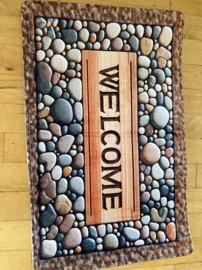 Mat with Welcome on it . Stones design on it. 76 x 50cm